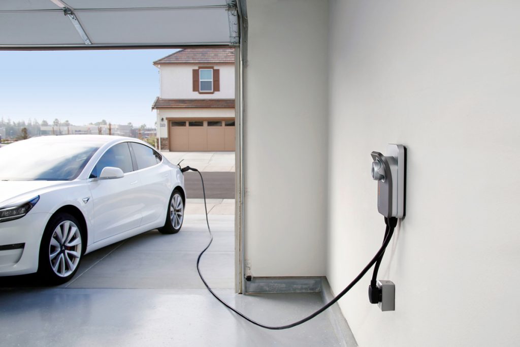 EV Charging Station Installation In Garage Plugged Into Car